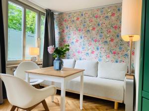 a living room with a couch and a table at Pension22 in Meißen