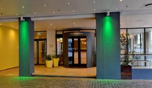 a lobby with green columns in a building at Cresta Grande Cape Town in Cape Town