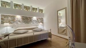 a bedroom with a bed and a mirror at Borgo del Nespolo in Peschici