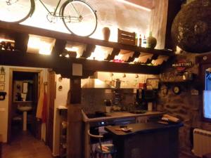 a kitchen with a bike on a shelf above a counter at Zaldierna al sol, aldea del siglo XVIII Ezcaray in Zaldierna