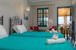 a bedroom with two beds and a couch at LITHARI PENTHOUSE in Alikanas
