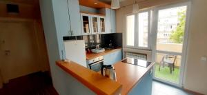 a small kitchen with a counter and a window at Apartment Alex 2 in Belgrade