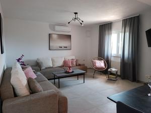 a living room with a couch and a table at Apartments Vidović in Sveti Petar