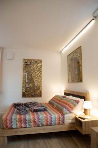a bedroom with a bed with a colorful blanket at Vespasiani Suites in San Benedetto del Tronto