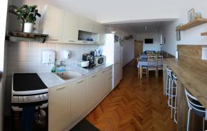 a kitchen with white cabinets and a counter top at Gile Guest House in Veliko Tŭrnovo