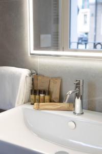 a bathroom sink with a mirror and a towel at Vespasiani Suites in San Benedetto del Tronto
