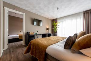 Habitación de hotel con cama y ventana en Maashof, en Venlo