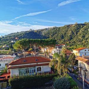 a view of a city with a mountain in the background at Made in Sicily Santa Tecla in Acireale