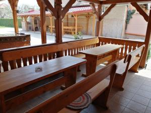 a porch with benches and tables in a pavilion at Ubytovanie Betty in Krásnohorské Podhradie