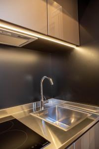 a kitchen with a sink and a counter top at Vespasiani SUITES & APARTMENTS in San Benedetto del Tronto