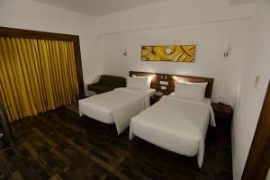 Voodi või voodid majutusasutuse Lemon Tree Hotel Coimbatore toas