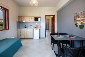 a kitchen and living room with a table and chairs at Anthos Apartments in Plakias