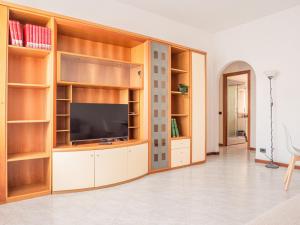 a living room with wooden shelves and a flat screen tv at The Best Rent - One-bedroom apartment in Washington district in Milan