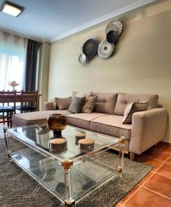 a living room with a couch and a glass table at Apartamento turístico en Sanxenxo in Sanxenxo