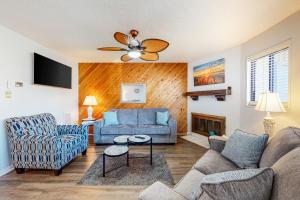 a living room with a couch and a chair at Runaway Bay 76 in Ocean City