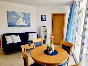a living room with a table and a couch at Sea view App Mirta in Umag