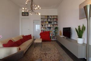 a living room with a couch and a tv at B&B BnBeach in Varazze