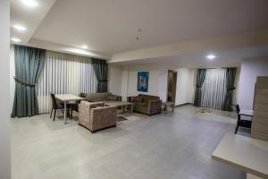 a living room with couches and a table and chairs at Sen Otel in Sakarya