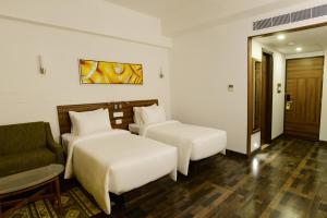 Voodi või voodid majutusasutuse Lemon Tree Hotel Coimbatore toas