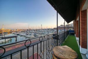 a balcony with a wooden table and a marina at Royal Harbour Retreat - Balcony, sea view property in Ramsgate