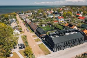 an aerial view of a small town with a street at OTTO Hotel & Sun in Pāvilosta