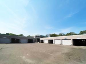 an empty parking lot in front of a building at Hotel ARUN in Yobito