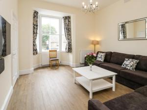 a living room with a couch and a table at Flat 3 in Saltburn-by-the-Sea