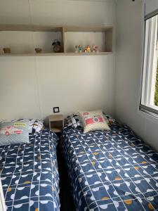 sypialnia z dwoma łóżkami i oknem w obiekcie Le mobilhome de Evelyne et Serge w mieście Lit-et-Mixe +23 zdjęcia