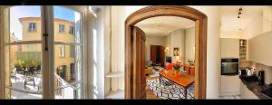 a hallway with an open door to a living room at Maison ÉGLANTINE Historic 4 star with Air Conditioning in Carcassonne