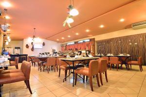 jadalnia ze stołami i krzesłami w restauracji w obiekcie Citystate Asturias Hotel Palawan w mieście Puerto Princesa