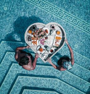 two people holding a table in the shape of a heart at Local Cave House Hotel in Göreme