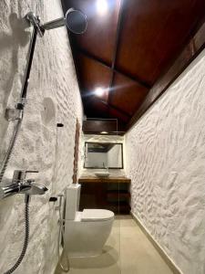 a bathroom with a toilet and a sink at Atholhu Residence in Fehendhoo