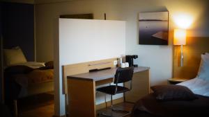 
a room with a bed and a television at Thon Partner Kristiansand Hotel in Kristiansand
