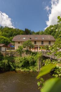a house with trees and a river at Zur Triftsperre in Passau