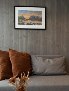 a living room with a couch with a picture on the wall at Modern apartment in Henningsvær in Lyngværet