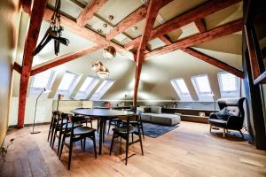 a dining room and living room with exposed beams at Hotel Liberty Offenburg in Offenburg
