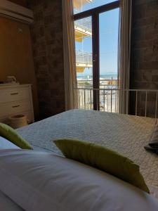 A bed or beds in a room at SWEET HOME & WELLNESS affittacamere