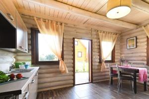 a kitchen with a table and a dining room at klub Karino 2 in Mikołajki