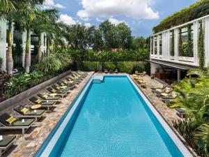 a swimming pool with lounge chairs and a resort at Viroth's Hotel in Siem Reap
