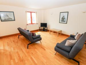 a living room with two chairs and a couch at 15 Sovereign House in Milford Haven