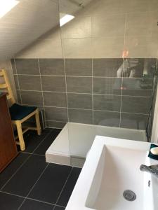 a bathroom with a sink and a bath tub at Luchon centre - maison de ville calme et lumineuse in Luchon