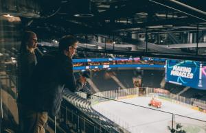 a man and a woman looking at a hockey rink at Lapland Hotels Arena in Tampere