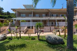 a view of the house from the garden at L' Arcobaleno Resort in Capo Vaticano