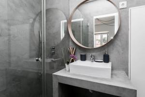La salle de bains est pourvue d'un lavabo, d'un miroir et d'une douche. dans l'établissement Santo Estevão by SpotOn Apartments, à Lisbonne