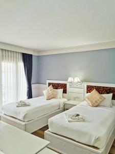 Postel nebo postele na pokoji v ubytování ริเวอร์บรีซ เชียงแสน River Breeze Chiangsean
