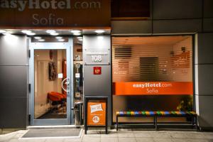 a store front with a sign in front of a building at easyHotel Sofia in Sofia