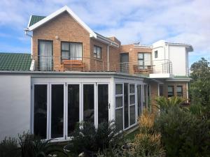 a house with a conservatory on top of it at The Sun Catcher B&B in Struisbaai