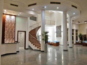 a lobby with a spiral staircase in a building at Vai by Romance Hotel & Aqua Park in Ain Sokhna