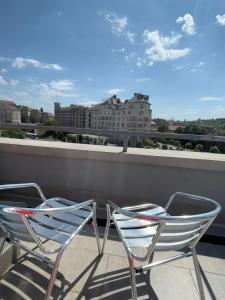 a couple of chairs sitting on a roof at Camille Apartmanhouse in Budapest