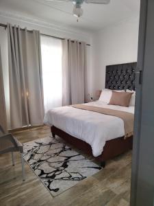 a bedroom with a large bed and a window at Molas Luxury Accomodation in Ga-Mothiba